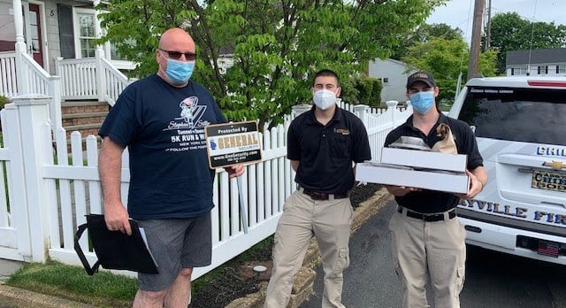 General Security employees John Doyle, Michael Minicozzi, and Alex Minicozzi deliver complimentary catered meals to hometown heroes of the Bayville Fire Department.