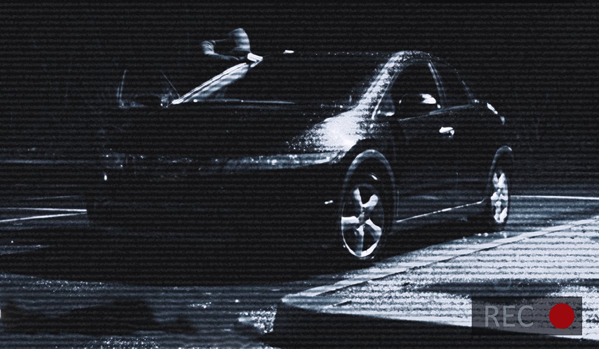 CCTV recording of thief looking at car in the darkness