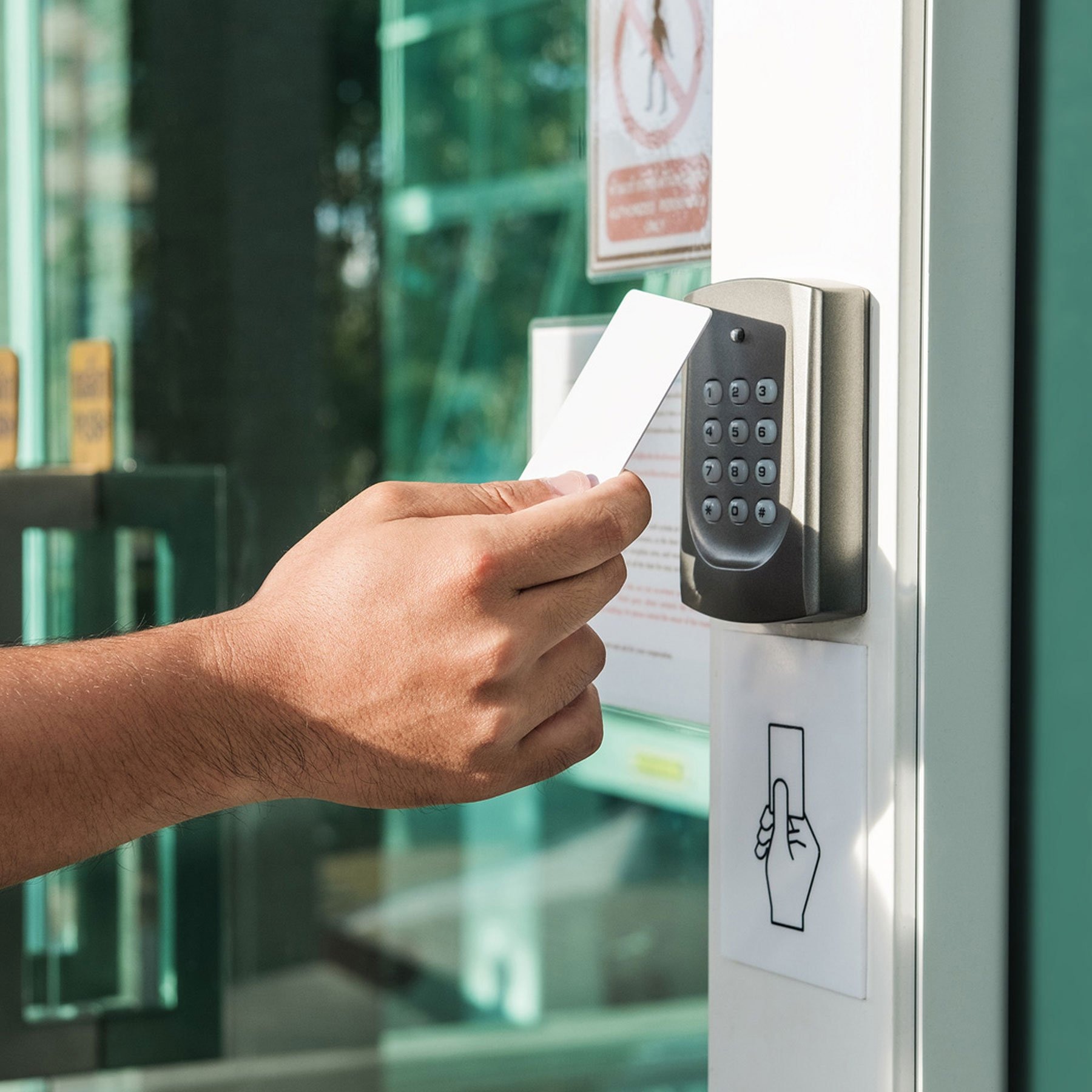 Person scanning card at commercial building entrance 