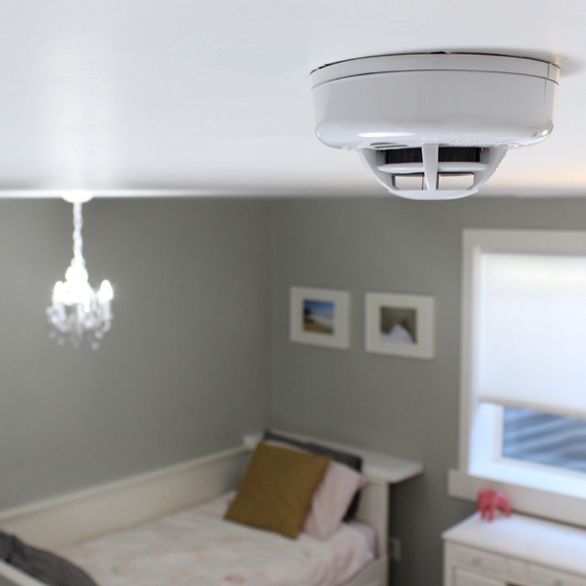 Qolsys IQ Smoke Detector on ceiling of bedroom