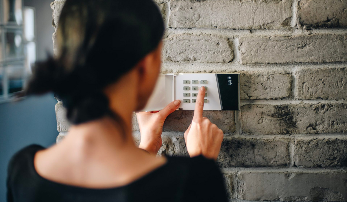 Girl entering code on alarm system