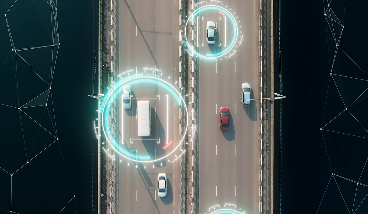 aerial view of self driving autopilot cars driving on a highway with technology tracking