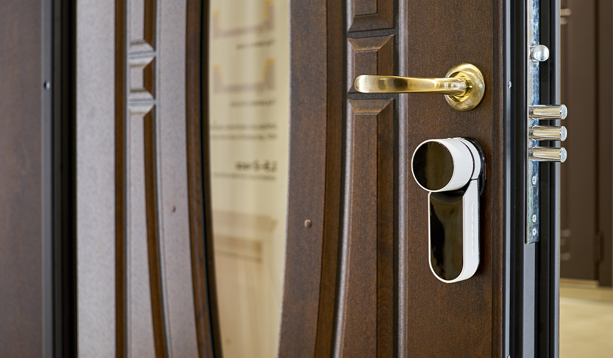 A closeup of a smart lock solution on a residential door.