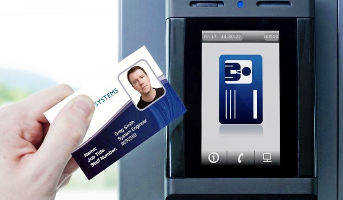 Closeup of worker scanning keycard with white males picture on it to access area