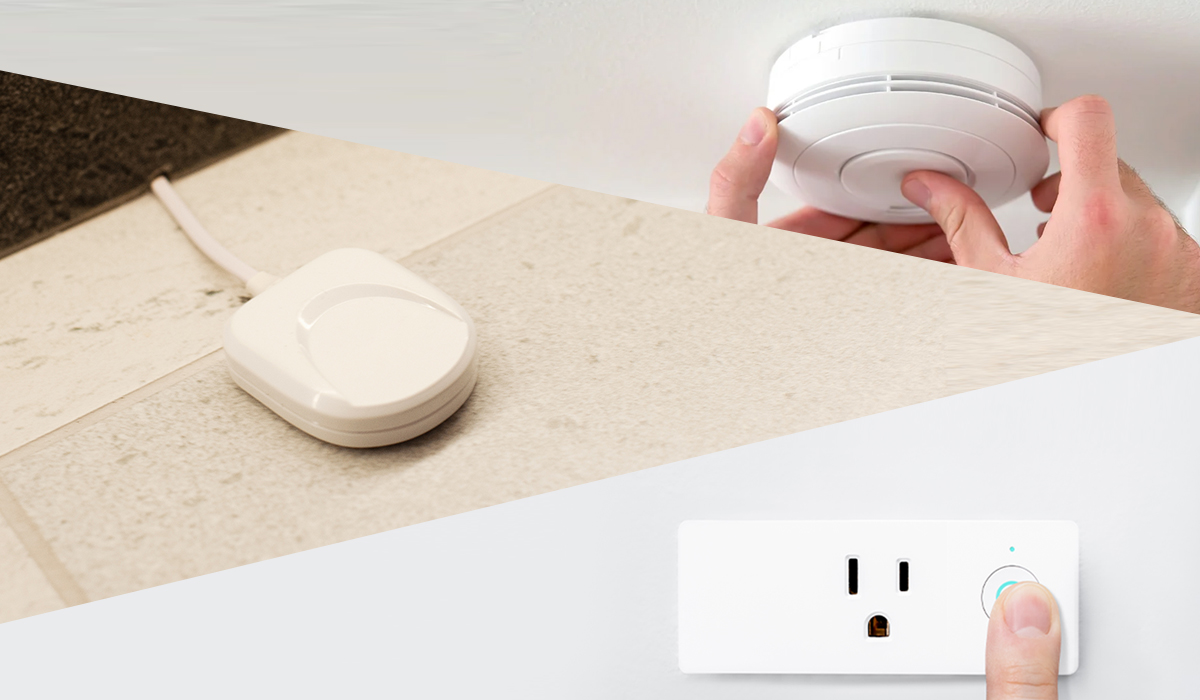Flood sensor with smart electrical outlet with power button being pressed and smoke detector