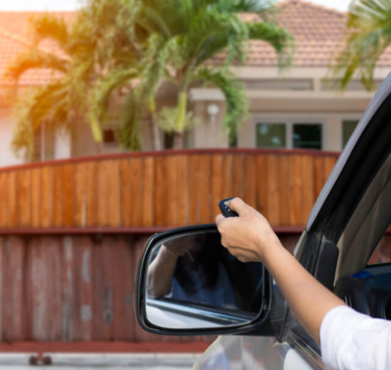 Women using gate controller out the car window