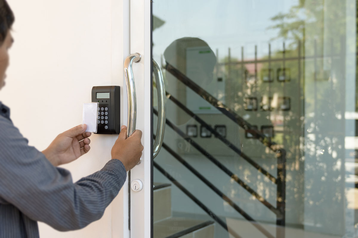 Man scanning card to enter commercial building